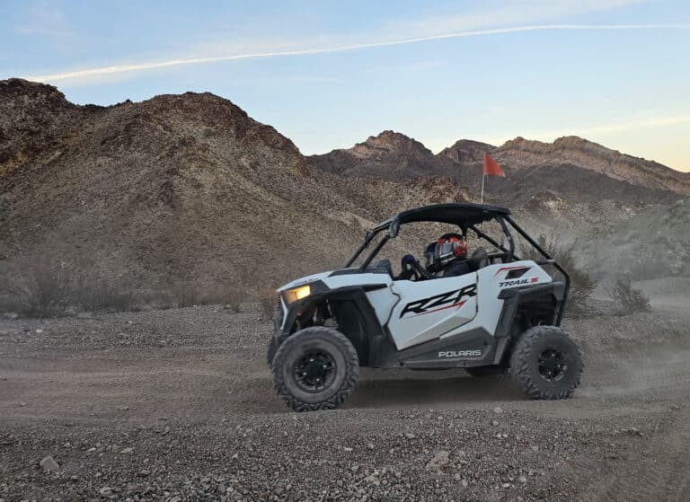 Polaris RZR off-road ATV rides along a dusty Nevada trail near Las Vegas, perfect for desert adventure and Ghost Town tours.