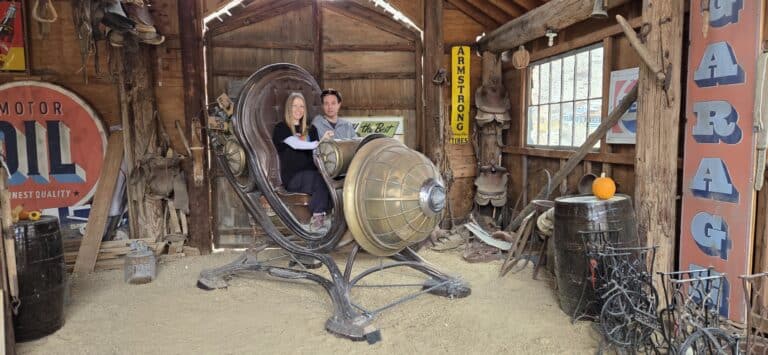 Experience a retro spaceship ride in a Nevada barn garage with vintage signs, antiques, and pumpkin—perfect for Ghost Town sightseeing.