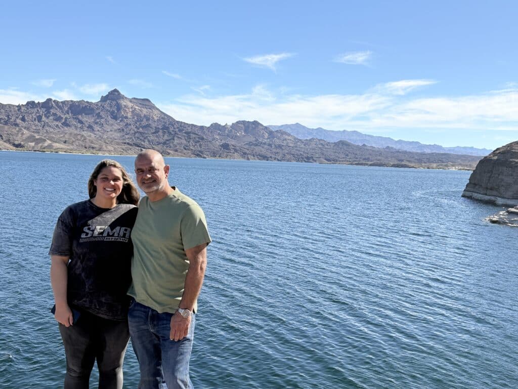 A happy couple by the Colorado River near Las Vegas, Nevada, with mountains beyond—perfect for ATV tours and RZR rides.