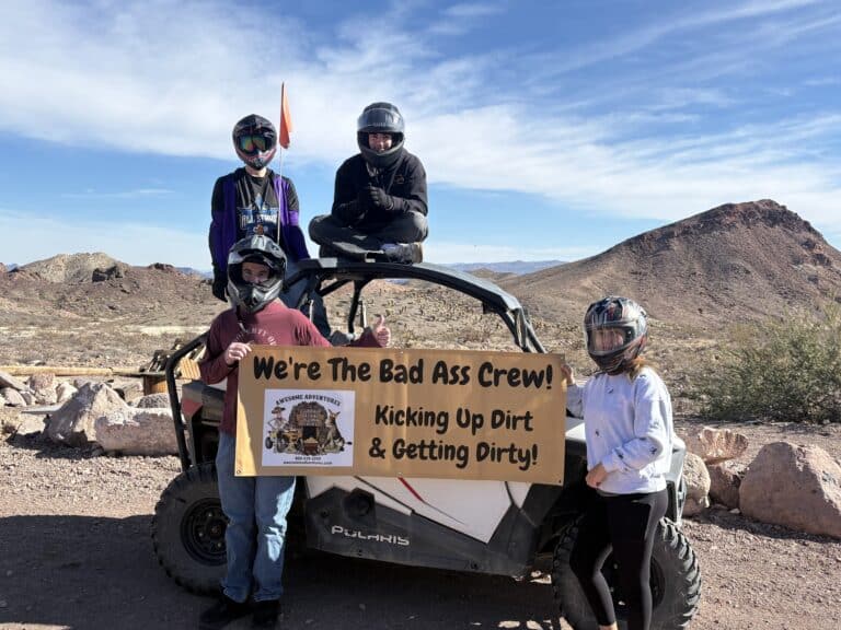 Adventurers in helmets on an ATV in Nevada, ready for thrilling Las Vegas RZR off-road and Ghost Town tour.
