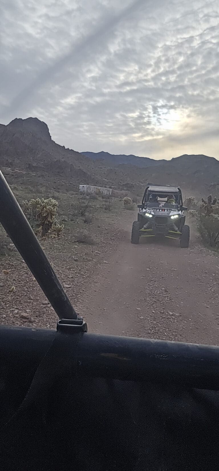 A rugged off-road vehicle tackles a Nevada desert trail near the Colorado River, perfect for RZR tours outside Las Vegas.