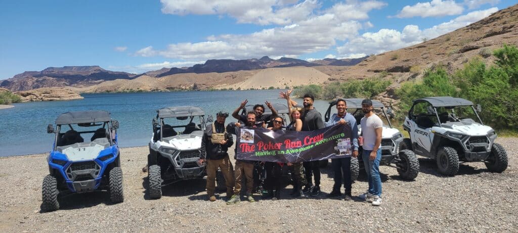 Poker Run Crew enjoying RZR off-road adventure by the Colorado River near Las Vegas, Nevada with mountain views.