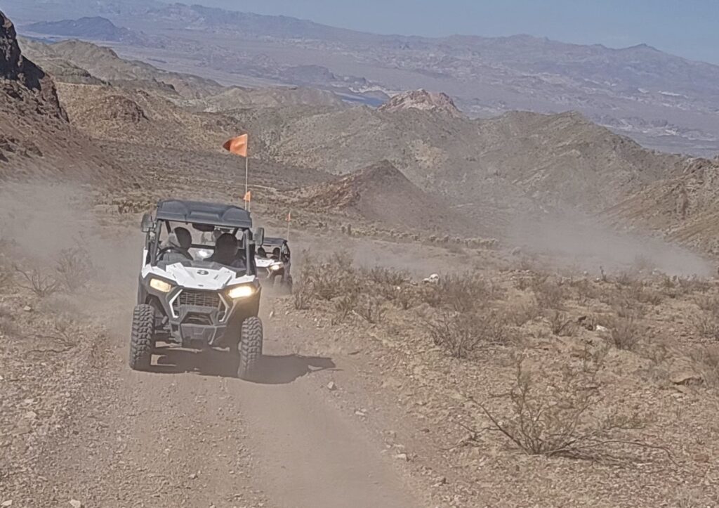 Experience an exciting RZR off-road ride near Las Vegas with two vehicles racing through Nevada’s desert trails, mountains, and scenic views.