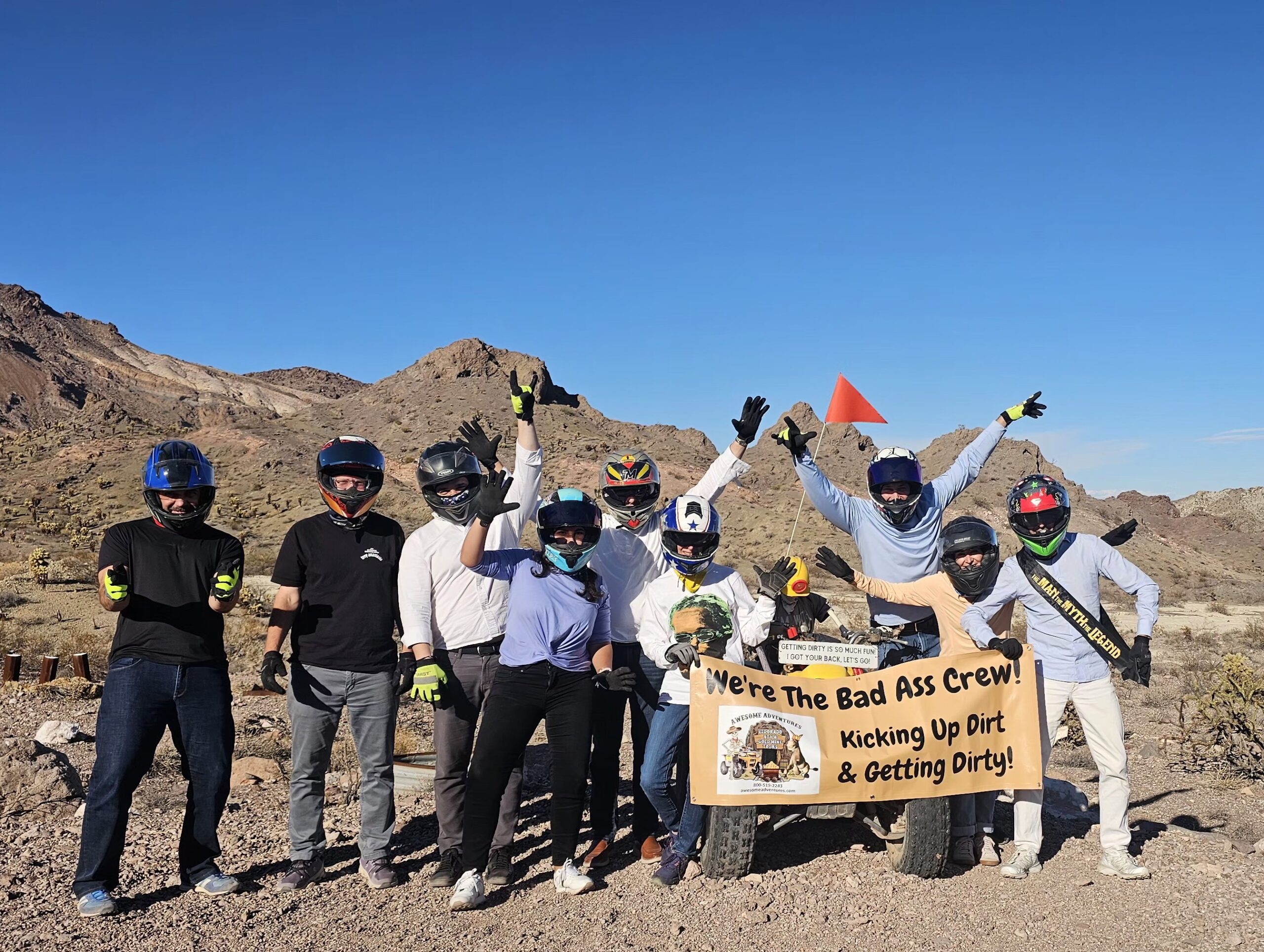 Nine adventurers pose in Eldorado Canyon, Nevada after a thrilling ATV tour near Las Vegas and the Colorado River.