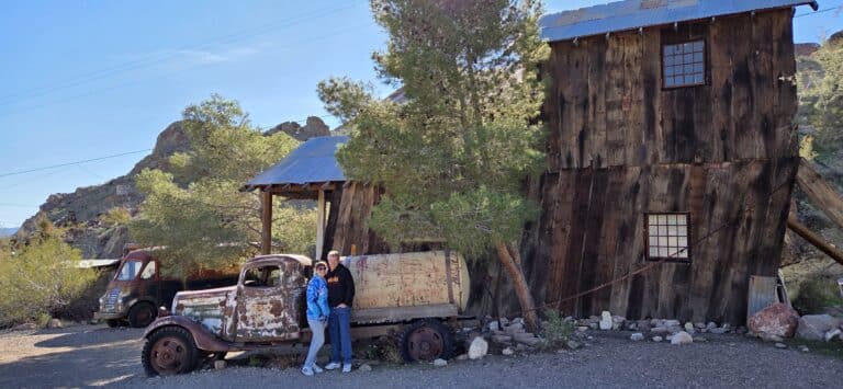 Visitors pose by a vintage truck at a Nevada ghost town near Las Vegas, perfect for ATV tours and Colorado River sightseeing.