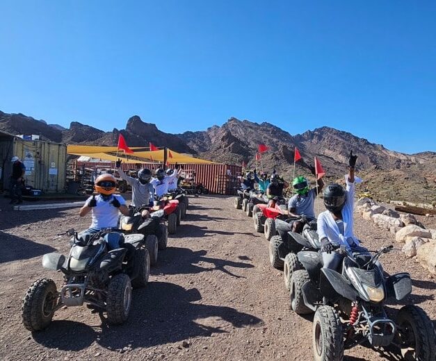 Helmets on, riders drive ATVs along a Nevada mountain trail near Las Vegas and the Colorado River on a thrilling ATV tour.