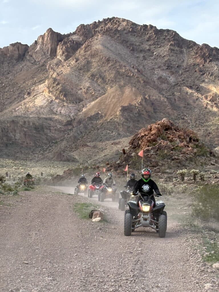 Adventure seekers enjoy ATV tours on a dusty Nevada desert trail near rocky mountains and the Colorado River outside Las Vegas.