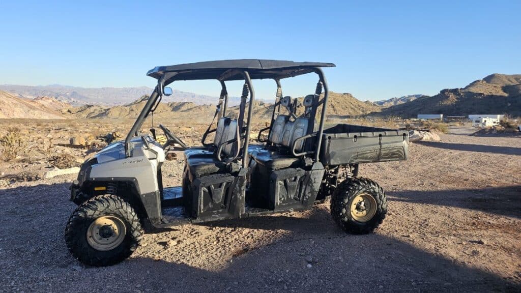 Black and gray ATV with four seats on a desert trail in Eldorado Canyon, Nevada—perfect for Las Vegas RZR tours or Ghost Town rides.