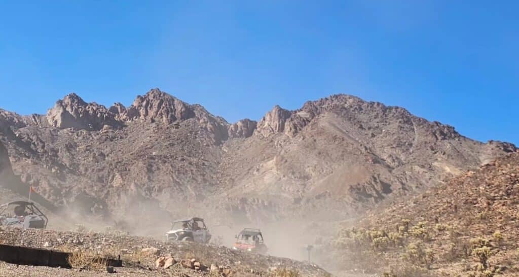 ATVs kick up dust on an Eldorado Canyon trail near Las Vegas, Nevada—ideal for RZR off-road rides and Ghost Town sightseeing.