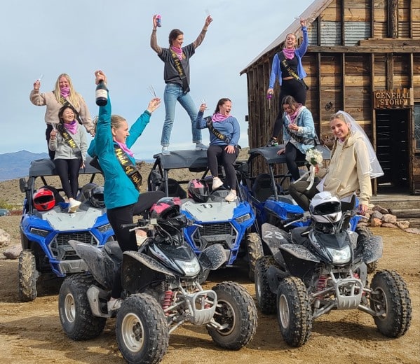 Women celebrating on ATVs in Eldorado Canyon, Las Vegas, Nevada, enjoying ATV tours and Ghost Town sightseeing adventure.