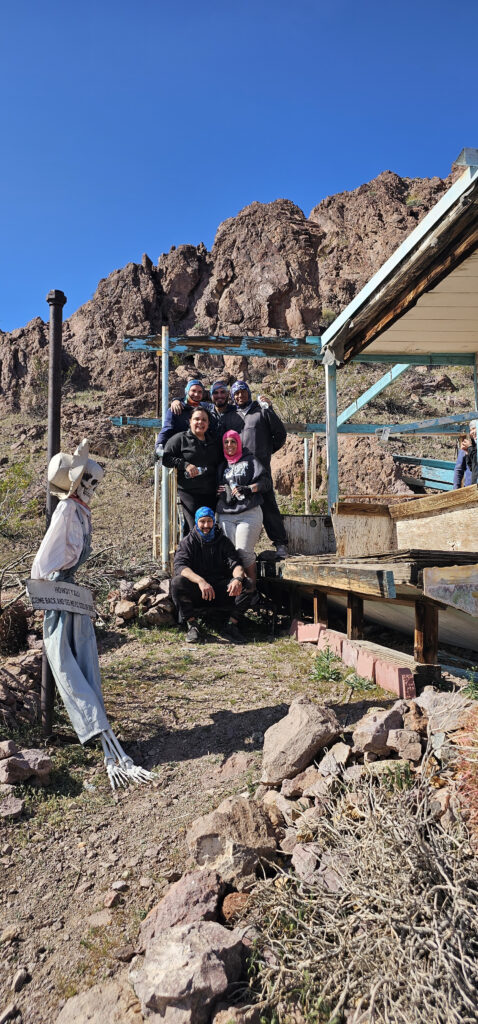 Group enjoying an ATV tour near the Colorado River, posing for a photo with scenic Nevada landscapes in Las Vegas.