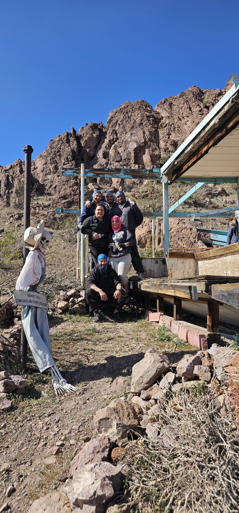 Group enjoying an ATV tour near the Colorado River, posing for a photo with scenic Nevada landscapes in Las Vegas.