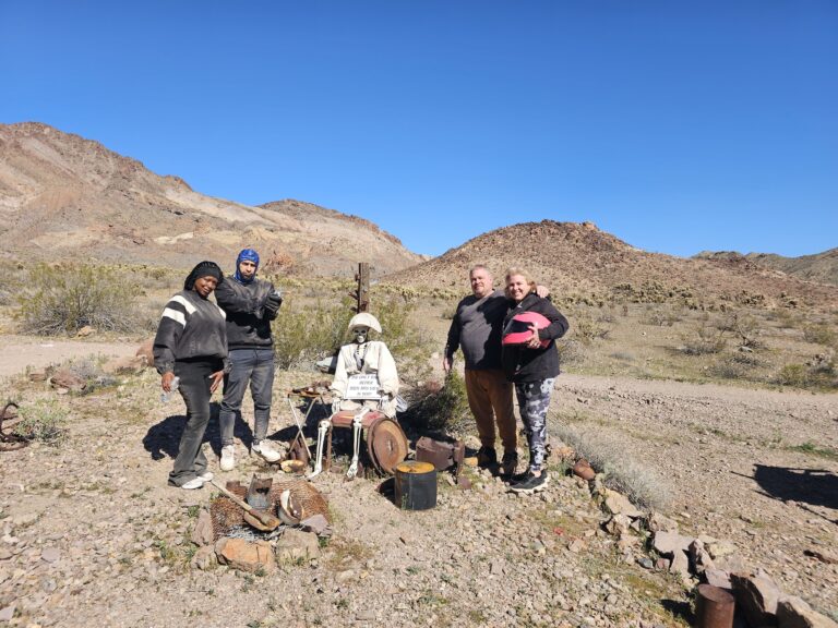 Group enjoying the Nevada desert near Las Vegas with mountains behind, perfect for RZR off-road rides and Ghost Town sightseeing.