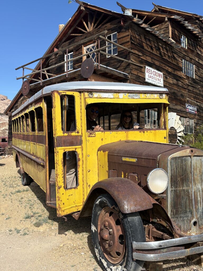 Vintage yellow school bus in a Nevada ghost town near the Colorado River, perfect for ATV tours and sightseeing adventures.