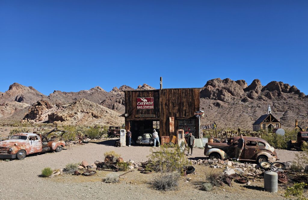 Explore Nevada’s ghost town near Las Vegas—rusty cars, vintage pumps, desert views by the Colorado River and rocky mountains.