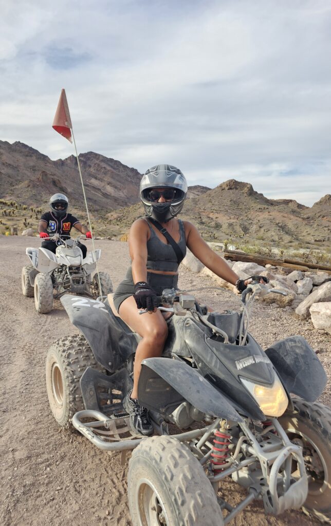 ATV riders explore a rocky desert trail near Las Vegas with mountains behind, enjoying a Nevada off-road adventure.