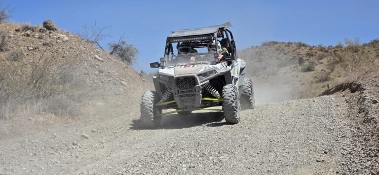 Rugged off-road vehicle on a dusty Nevada desert trail near Las Vegas, perfect for ATV tours and RZR rides under blue skies.