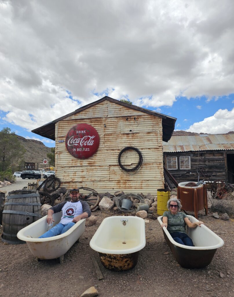 Relax in old bathtubs outside a Nevada ghost town near Las Vegas, with vintage signs—perfect for sightseeing after ATV tours.