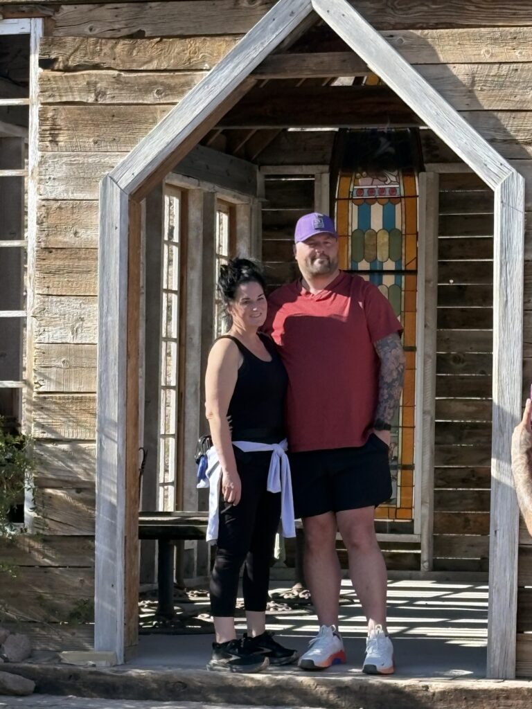 Couple posing under a rustic archway in Nevada Ghost Town near Las Vegas, ready for ATV and RZR off-road adventure tours.