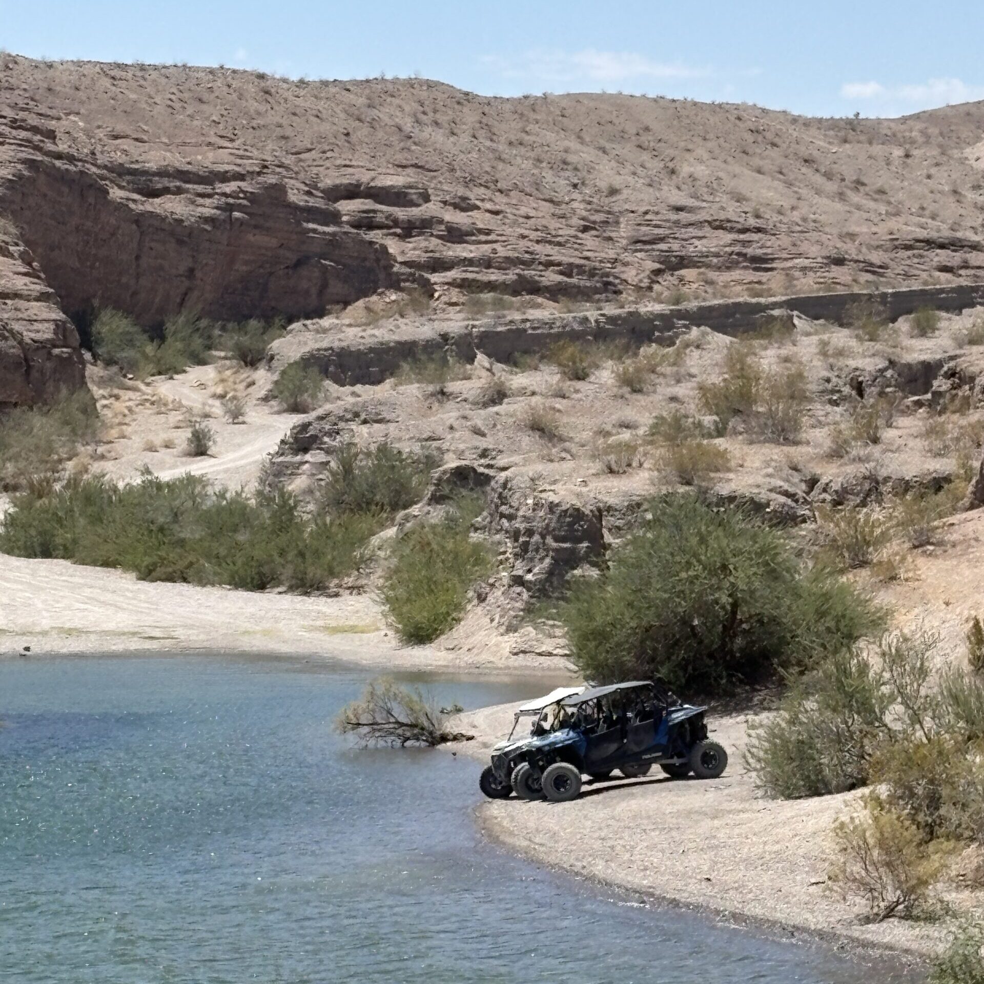 A UTV parked on sandy shore by the Colorado River near Las Vegas, Nevada—perfect for RZR off-road rides and ATV tours.