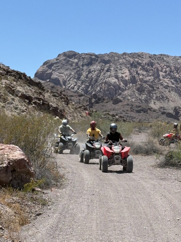 Explore a thrilling Las Vegas ATV tour on a dusty Nevada desert trail with rocky hills near the Colorado River.