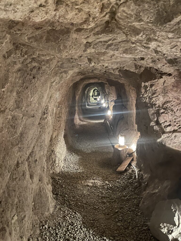 Explore a dimly lit, stone-walled tunnel near the Colorado River in Nevada—perfect for ATV tours or Ghost Town adventures.