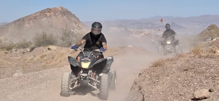 Adventurers riding ATVs on a dusty Nevada desert trail near Las Vegas, perfect for scenic ATV tours and Colorado River views.