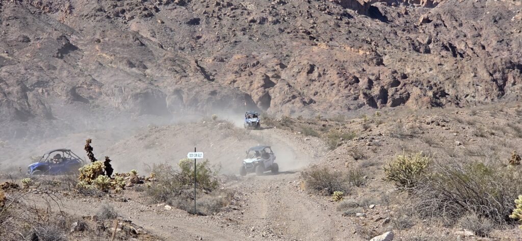 ATVs explore a rocky Nevada desert trail near Nelson, close to Las Vegas and the Colorado River—perfect for RZR off-road tours.