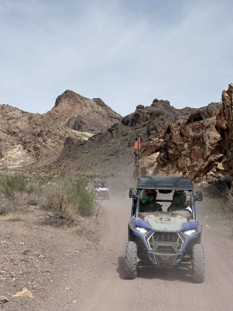 Adventurers enjoy RZR off-road rides near the Colorado River, Nevada, close to Las Vegas and rocky desert mountains.