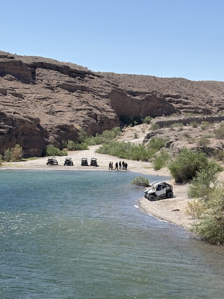 ATVs parked by the Colorado River in Nelson, Nevada, enjoy stunning desert views on a Las Vegas RZR off-road adventure tour.