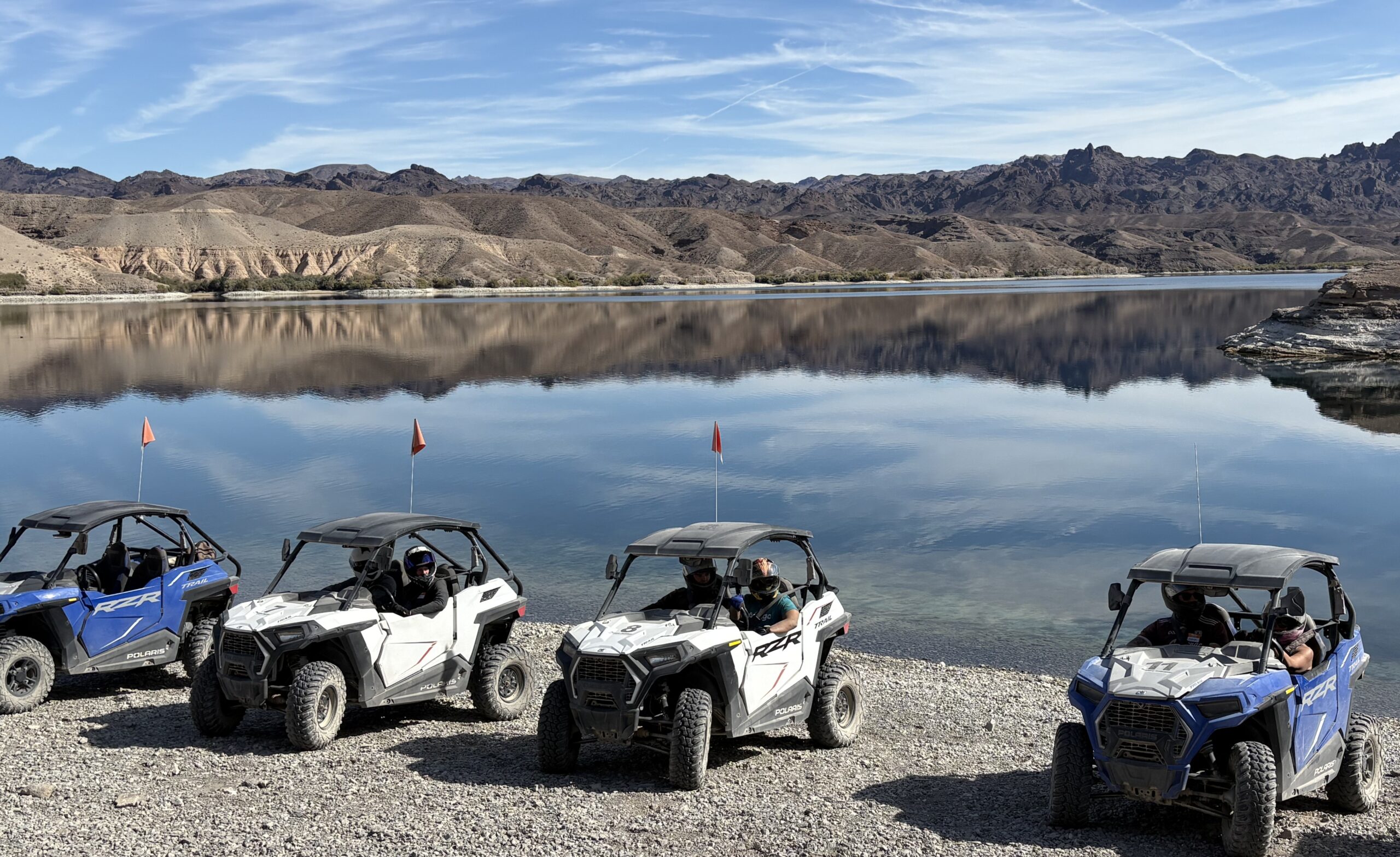 ATVs and RZRs parked lakeside near the Colorado River, Nevada—Las Vegas off-road adventure tours with desert mountain views.