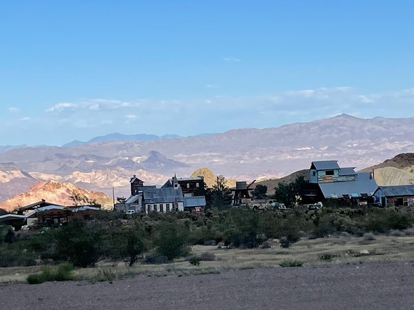 Rustic buildings in a Nevada desert near Las Vegas with mountains, ideal for ATV tours or Ghost Town sightseeing.