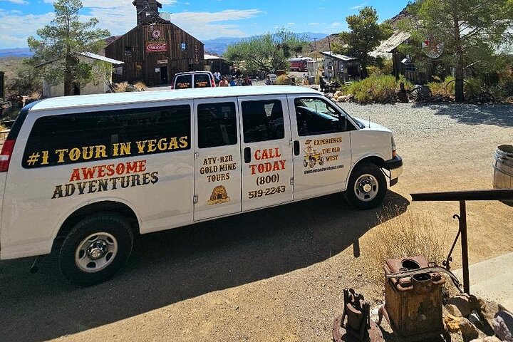 Awesome Adventures tour van at a Nevada Ghost Town near Las Vegas, offering gold mine tours, ATV rides, and Colorado River trips.